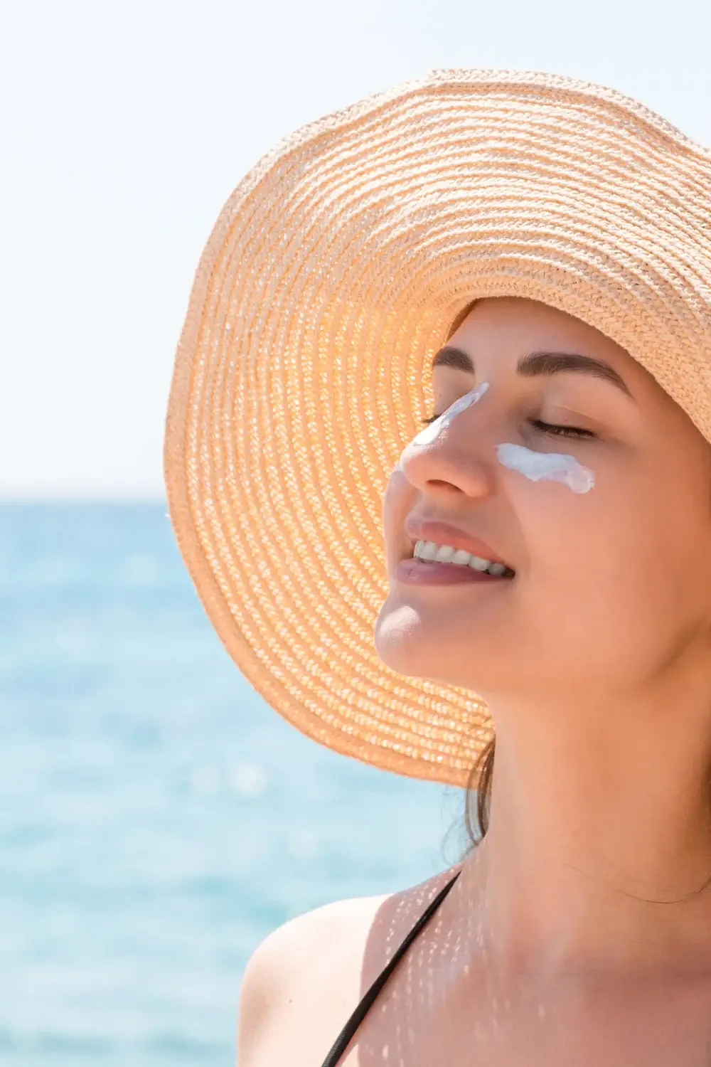 Woman applying sunscreen to protect her skin from the Georgia sun in Augusta, GA