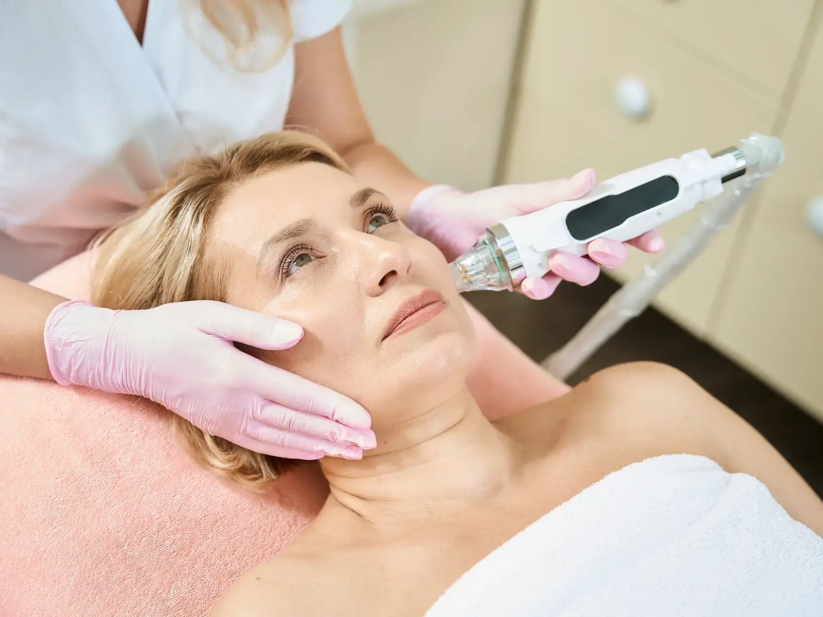 A clinician performing Morpheus8 radiofrequency microneedling on a patient's face and jawline at 7 Seas Medical Spa in Augusta, GA